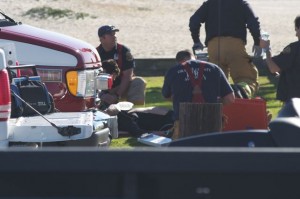 Paramedics working on a man saved by surfers ...